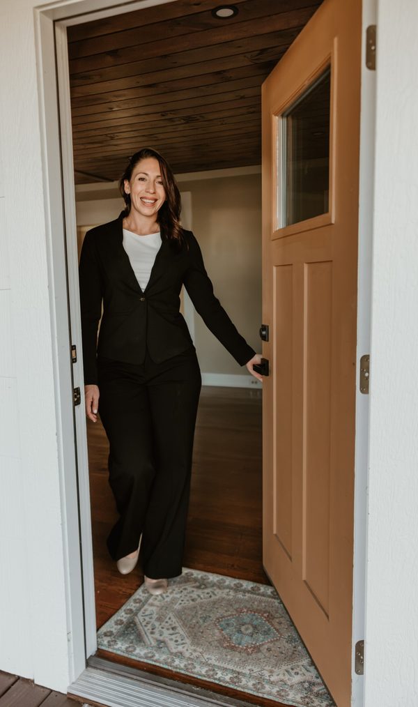 Brandi Rininger opening the front door of a home in Franklin, NC