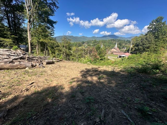 Wide look across the cleared pad toward the mountains