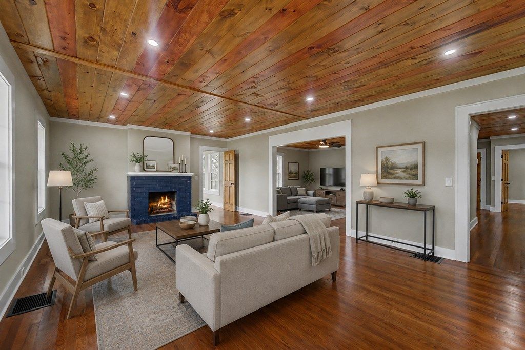 Living room with a navy brick fireplace, shown with virtual furniture