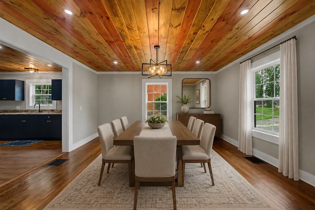 Dining room open to the kitchen, shown with a virtual dining table and chairs