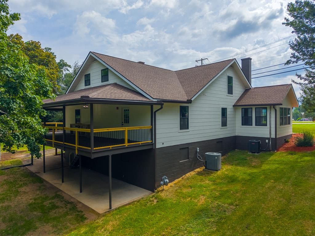 Rear of the house showing the covered back porch above a covered patio and the daylight basement