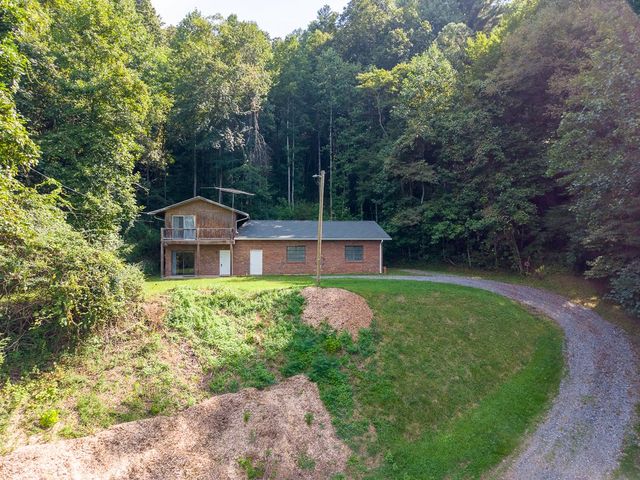 Home and gravel driveway from below