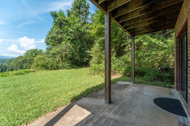 Covered lower patio looking out to the yard and the mountains