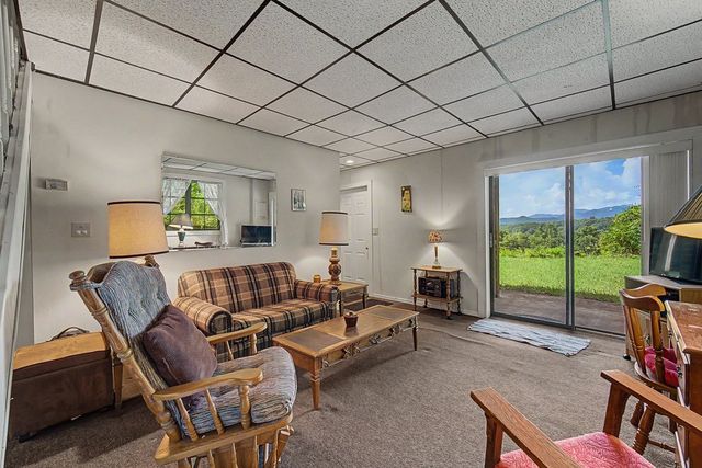 Living room with a sliding door to the patio and a mountain view