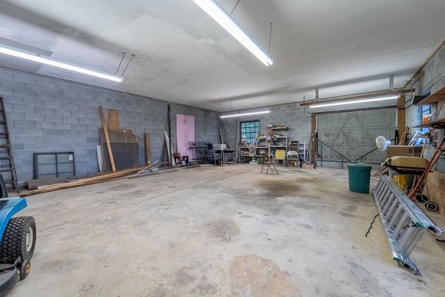 Large garage and workshop with a concrete floor