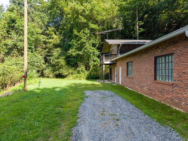 Side of the brick garage wing and the driveway