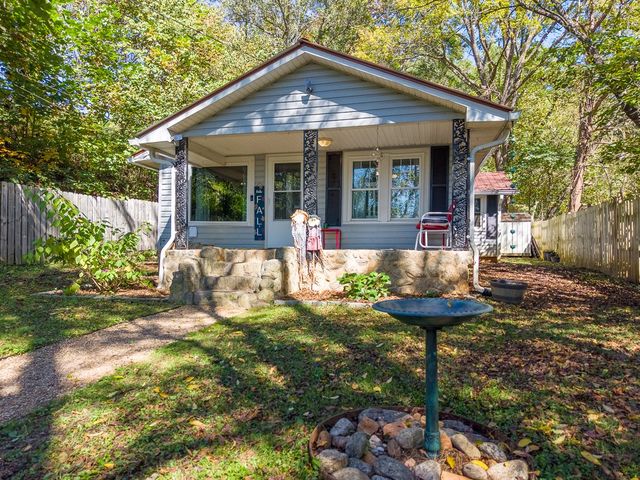 Front porch and stone foundation from the yard