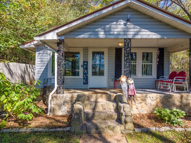 Covered front porch with decorative iron posts