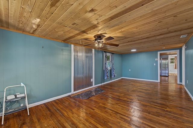 Living room with hardwood floors and a tongue-and-groove wood ceiling