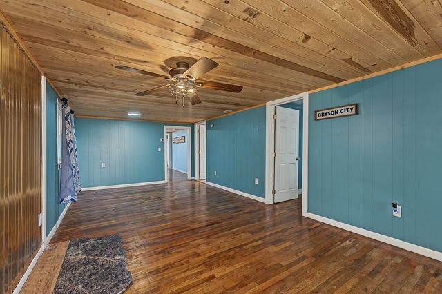 Living area with a ceiling fan and wood ceiling