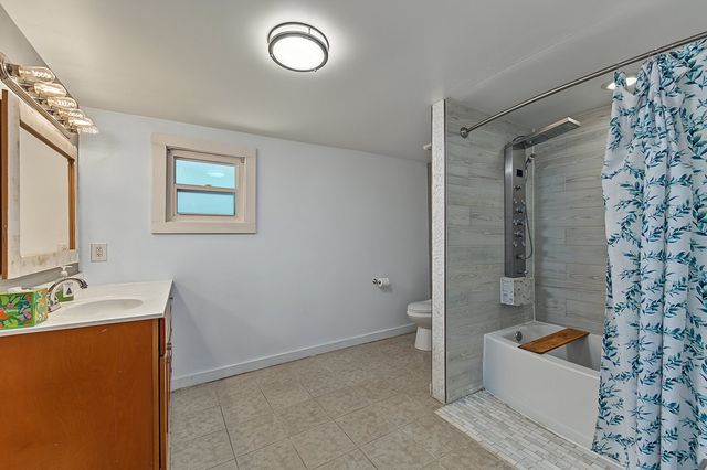 Bathroom with a tiled shower and tub