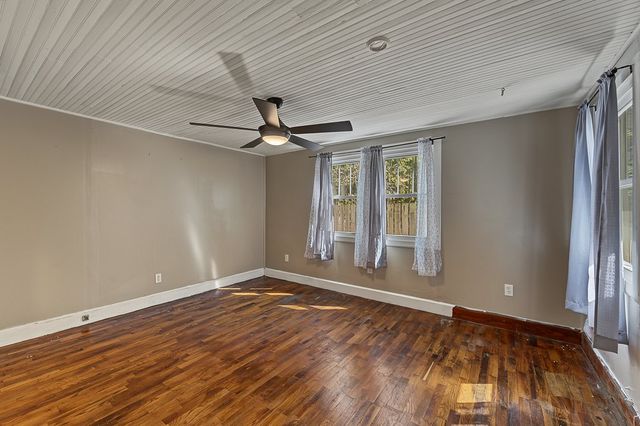 Room with hardwood floors and a ceiling fan