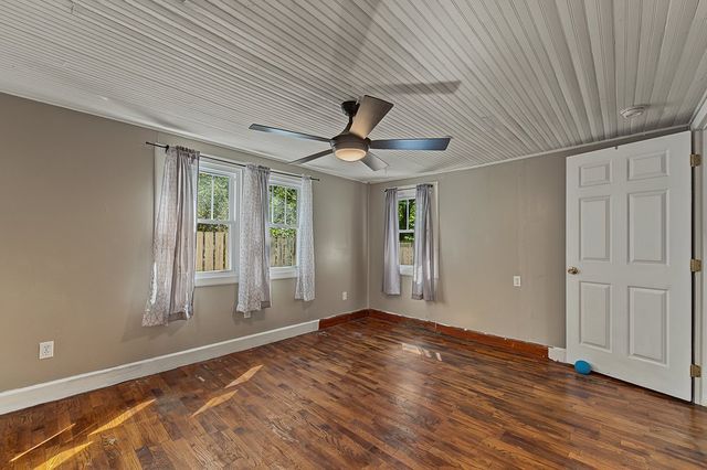 Room with hardwood floors and two windows