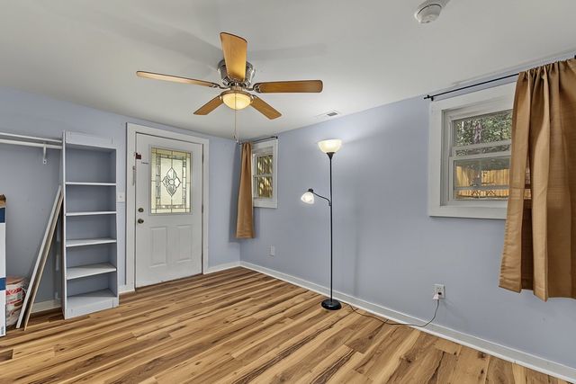 Room with built-in shelves and an exterior door