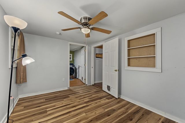 Room with a ceiling fan, looking toward the laundry