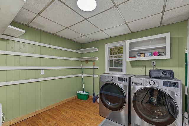 Laundry room with washer, dryer and shelving