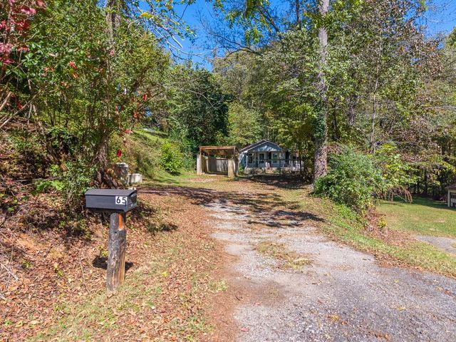 Gravel driveway and mailbox at the road