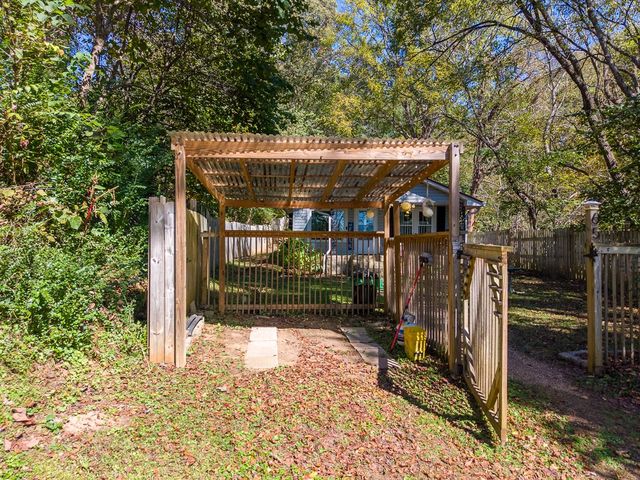 Pergola-covered gate into the front yard