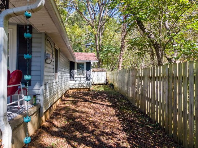 Side yard between the house and the fence
