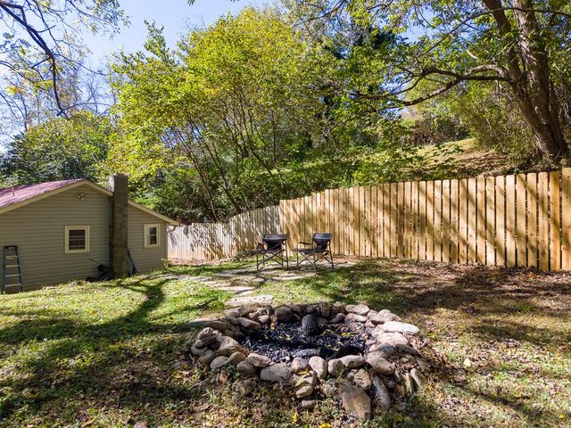 Backyard fire pit with the house at left