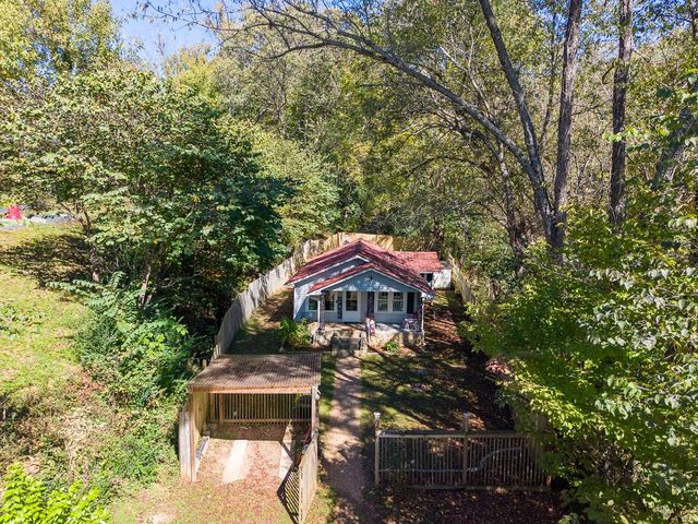 Aerial view of the house, fenced yard and pergola gate